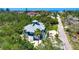 Charming home with a two-car garage and lush landscaping, offering a serene and private setting at 540 Gulf Bay Rd, Longboat Key, FL 34228