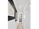 Hallway features black and white walls, white trim, light hardwood floors, and modern art at 540 Gulf Bay Rd, Longboat Key, FL 34228