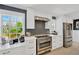 Bright kitchen features white cabinets, stainless steel appliances, and modern countertops with backsplash at 540 Gulf Bay Rd, Longboat Key, FL 34228