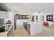 A kitchen boasts stainless appliances, quartz countertops with a large island perfect for gathering and entertaining at 540 Gulf Bay Rd, Longboat Key, FL 34228