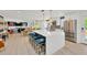 Open concept featuring stainless appliances, large kitchen island with seating, and dining and living area at 540 Gulf Bay Rd, Longboat Key, FL 34228