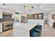 Open kitchen with stainless appliances, quartz countertops with a large island, and pendant lighting at 540 Gulf Bay Rd, Longboat Key, FL 34228