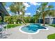 Inviting backyard pool with palm trees, poolside bar and plenty of lounge seating at 540 Gulf Bay Rd, Longboat Key, FL 34228