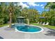 Backyard pool featuring tropical landscaping and a cozy poolside bar area; an oasis for relaxation and fun at 540 Gulf Bay Rd, Longboat Key, FL 34228