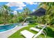 Inviting backyard pool with bar, perfect for relaxation; framed by lush greenery and a serene ambiance at 540 Gulf Bay Rd, Longboat Key, FL 34228