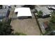 Aerial view of home showcasing a spacious backyard, mature trees, and perimeter fencing at 5417 Golden Dr, Tampa, FL 33634