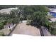 A high angle shot of an empty fenced in yard with lush green trees surrounding the property at 5417 Golden Dr, Tampa, FL 33634