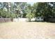 Large, grassy backyard features a shed, tall privacy fence, and mature trees, providing ample space for outdoor activities at 5417 Golden Dr, Tampa, FL 33634