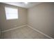 Cozy bedroom with tile flooring and window at 5417 Golden Dr, Tampa, FL 33634