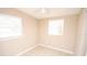 A secondary bedroom with a ceiling fan and two large windows at 5417 Golden Dr, Tampa, FL 33634