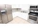 Well-equipped kitchen featuring stainless steel appliances and white cabinets, perfect for cooking at 5417 Golden Dr, Tampa, FL 33634