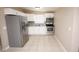 Modern kitchen with stainless steel appliances, white cabinetry and tile floors at 5417 Golden Dr, Tampa, FL 33634