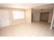 Bright living room featuring tiled floors, large window, and a view into adjoining rooms at 5417 Golden Dr, Tampa, FL 33634