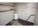 Utility room features a water heater, shelving, and concrete floors, offering functional space for storage and utilities at 5417 Golden Dr, Tampa, FL 33634