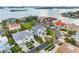 Stunning aerial view of a coastal home featuring lush landscaping and waterfront views at 6024 Kipps Colony E Dr, Gulfport, FL 33707