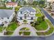 Aerial view of a white home featuring a circular driveway, and lush, green landscaping at 6024 Kipps Colony E Dr, Gulfport, FL 33707