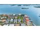 Stunning aerial view of a waterfront community showcasing luxurious homes and picturesque harbor views at 6024 Kipps Colony E Dr, Gulfport, FL 33707