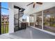 Balcony with spiral staircase, a ceiling fan, and a dining table visible through the glass door at 6024 Kipps Colony E Dr, Gulfport, FL 33707