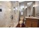 Bathroom featuring a modern marble shower, toilet and dark wood vanity with a stone countertop at 6024 Kipps Colony E Dr, Gulfport, FL 33707