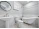 Classic bathroom with a pedestal sink and a beautiful clawfoot bathtub at 6024 Kipps Colony E Dr, Gulfport, FL 33707
