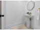 Elegant powder room with a pedestal sink, modern fixtures, and decorative octagon mirror at 6024 Kipps Colony E Dr, Gulfport, FL 33707