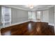 Bedroom featuring hardwood floors, gray walls with paneling and lots of natural light from two large windows at 6024 Kipps Colony E Dr, Gulfport, FL 33707