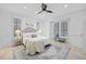 Bright bedroom features neutral decor, ceiling fan, and charming bench seating beneath window at 6024 Kipps Colony E Dr, Gulfport, FL 33707