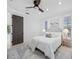 Bright bedroom features neutral decor, ceiling fan, and entry to balcony at 6024 Kipps Colony E Dr, Gulfport, FL 33707