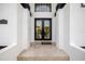 Inviting entryway showcasing double doors, travertine tile, and a modern address plaque for a grand entrance at 6024 Kipps Colony E Dr, Gulfport, FL 33707