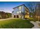 Stunning three-story home with a well-manicured lawn, two-car garage and a walkway surrounded by white rocks at 6024 Kipps Colony E Dr, Gulfport, FL 33707