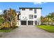 Two-story house with a two-car garage, well-manicured lawn, and lovely landscaping at 6024 Kipps Colony E Dr, Gulfport, FL 33707