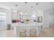 Bright kitchen features a large island with seating, pendant lighting, and modern appliances at 6024 Kipps Colony E Dr, Gulfport, FL 33707