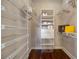 Walk-in closet featuring ample storage shelves, hanging racks and drawers for clothing and accessories at 6024 Kipps Colony E Dr, Gulfport, FL 33707