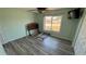 Bright bedroom with light walls, wood-look floors, and a large window creating a cozy, adaptable space at 6405 Klaus Ct, Port Charlotte, FL 33981