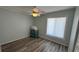 Bright, airy bedroom featuring vinyl floors, a ceiling fan, and a large window, offering a serene retreat at 6405 Klaus Ct, Port Charlotte, FL 33981