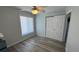 Bright bedroom featuring a large window, closet, and wood-look floors, offering a clean and modern design at 6405 Klaus Ct, Port Charlotte, FL 33981
