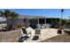Rear exterior view showing the patio, sunroom, and backyard space at 6405 Klaus Ct, Port Charlotte, FL 33981