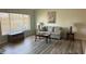 Cozy living area with wood-look floors, a bright window, comfortable seating, and stylish decor at 6405 Klaus Ct, Port Charlotte, FL 33981