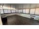 Spacious sunroom featuring dark floors and many windows, blinds are drawn at 6405 Klaus Ct, Port Charlotte, FL 33981