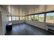 Bright sunroom boasts wood-look floors and plenty of natural light from numerous windows at 6405 Klaus Ct, Port Charlotte, FL 33981
