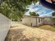 Paver brick drive leads to cozy backyard surrounded by white fencing, promising privacy and outdoor enjoyment at 6423 Boxwood St, Brooksville, FL 34602