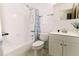 This well-lit bathroom includes a shower and bath, a vanity with storage, and updated fixtures at 6423 Boxwood St, Brooksville, FL 34602
