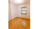 Bedroom with wood floor and window offering natural light, a minimalist space at 6423 Boxwood St, Brooksville, FL 34602