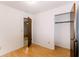 Cozy bedroom with a closet, hardwood floors, and a view of the en-suite bathroom at 6423 Boxwood St, Brooksville, FL 34602