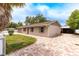 Charming single-story home with brick driveway, manicured lawn, fenced yard and an attached garage at 6423 Boxwood St, Brooksville, FL 34602