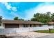 Charming single-story home with a brick driveway, well manicured lawn, and a fenced yard at 6423 Boxwood St, Brooksville, FL 34602