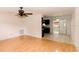 Open concept living room boasts hardwood floors and ceiling fan, perfect for entertaining at 6423 Boxwood St, Brooksville, FL 34602
