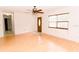 Bright living room featuring hardwood floors, a ceiling fan, and a front door entrance at 6423 Boxwood St, Brooksville, FL 34602