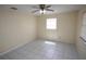 Bright bedroom featuring neutral walls, a ceiling fan, and tiled floors, creating a comfortable living space at 6508 Los Altos Way, Tampa, FL 33634