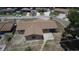 Aerial view of a home featuring a driveway, backyard patio, and partial fencing in a neighborhood setting at 6514 La Mesa Cir, Tampa, FL 33634
